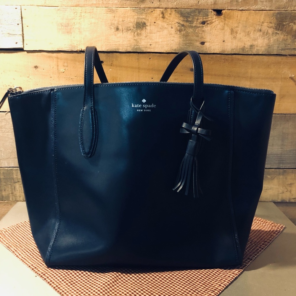 Beautiful like new large Kate Spade navy blue tote with tassel.